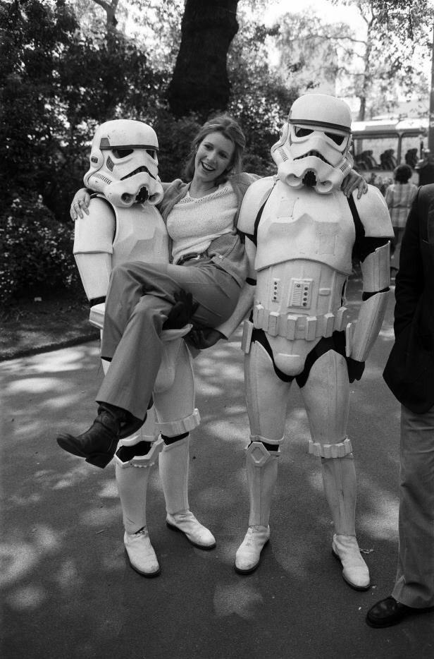 Carrie Fisher (Princess Leia) alongside the Imperial Stormtroopers during an Empire Strikes Back promotion in London in 1980 - Star Wars, Princess Leia, Carrie Fisher, Star Wars stormtrooper, Promo, Star Wars V: The Empire Strikes Back, 1980, London, , England, Black and white photo, Retro