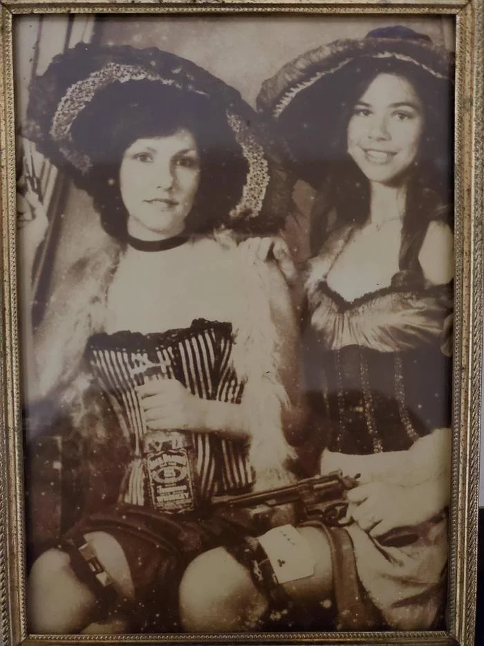 My mom (with a bottle of whiskey) and her best friend are having fun at a carnival, Texas, early 1980s - Girls, Costume, Wild West, Carnival, Texas, 80-е, Black and white photo, Reddit